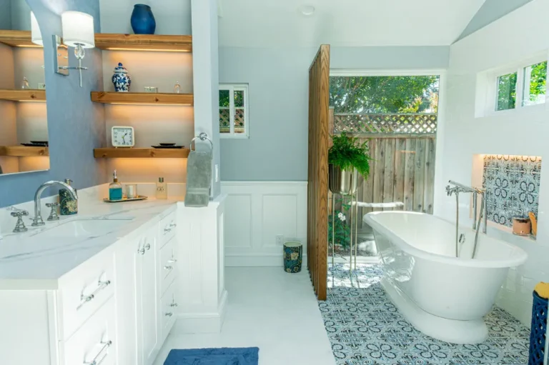 Bathroom remodeling project with freestanding tub, custom tile, double vanity, and natural light