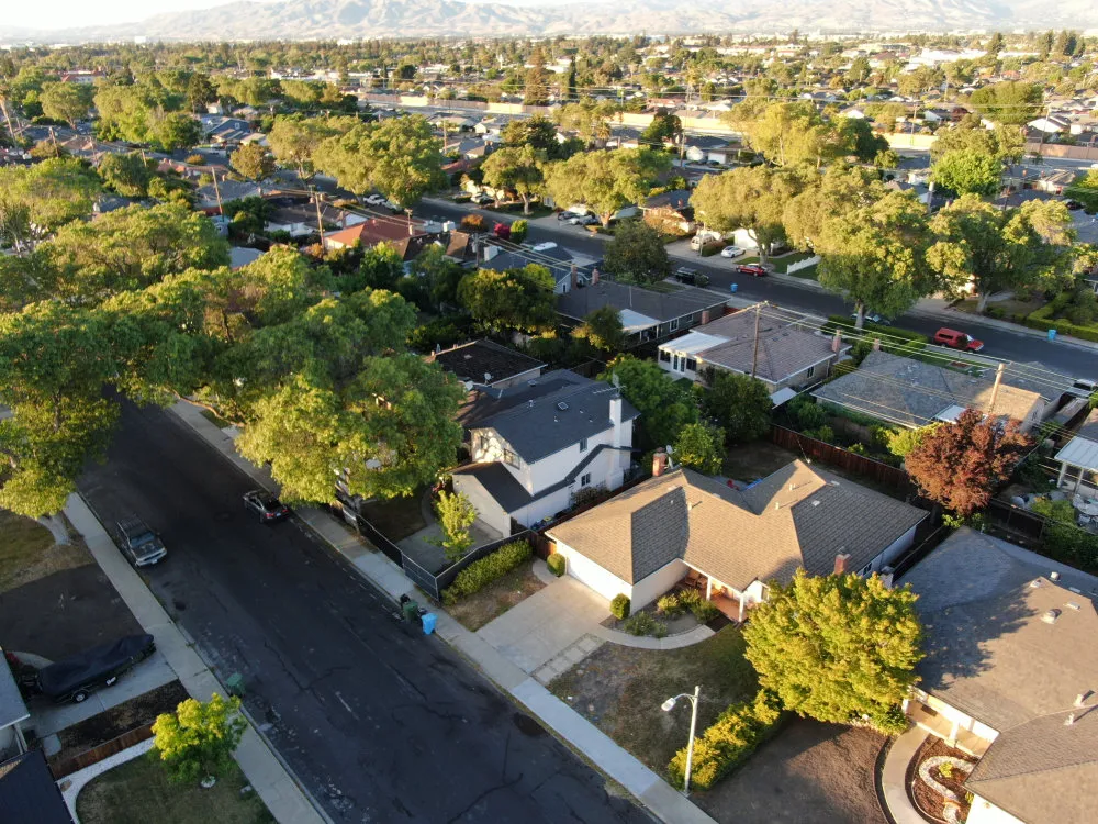 Preconstruction planning for a residential neighborhood project with aerial views of homes and surrounding streets