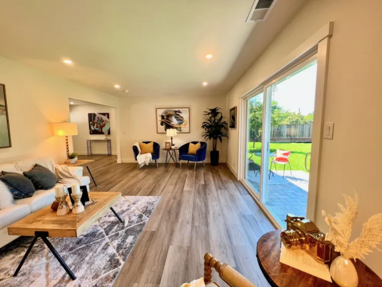 Remodeling project with open living space, updated flooring, large sliding glass doors, and natural light
