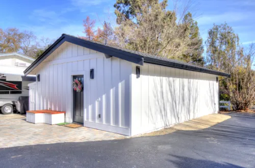 ADUs Construction with a detached backyard structure beside a paved driveway