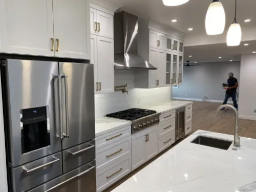 General contractor kitchen remodel with white cabinetry, quartz counters, and active installation